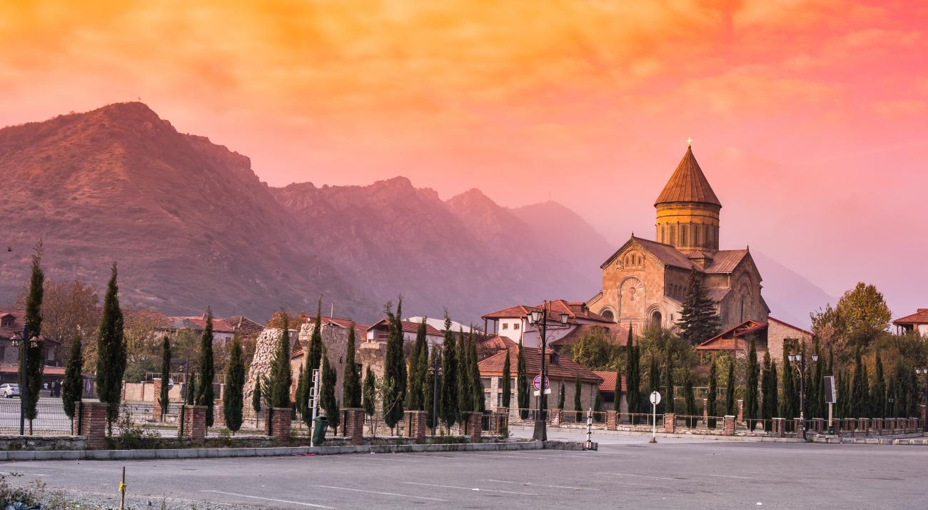 Church in Georgia at sunset with views of mountains